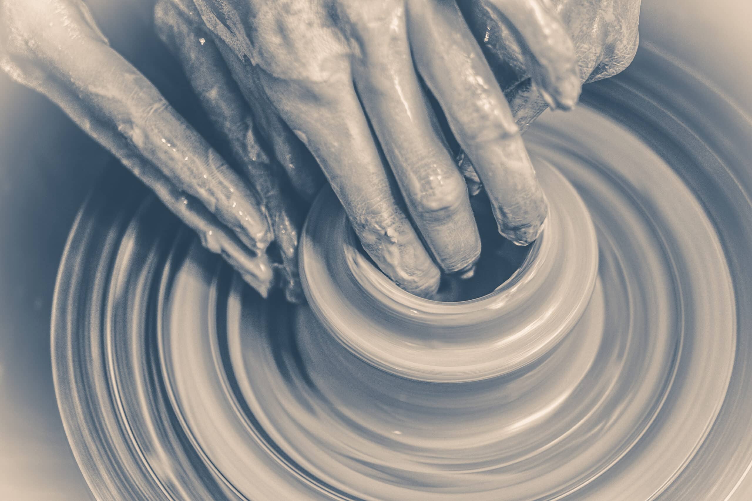 manos colaborando para moldear un elemento fluido, representando la co-creación y la conversación cultural de una marca líquida.